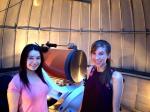 Ariel Graykowski (right) with friend by a telescope at&nbsp;observatory